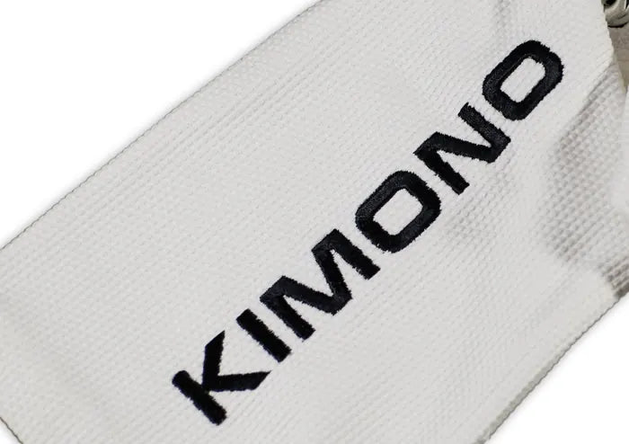 Real product photo, close up: KIMONO embroidered on the white pearl weave